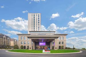 a large building with a sign in front of it at Howard Johnson by Wyndham Jufu Plaza Jinxi in Fuzhou