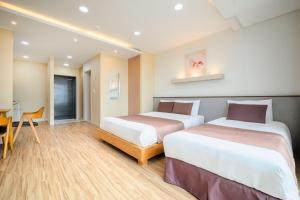 Postel nebo postele na pokoji v ubytování Jeju M Resort