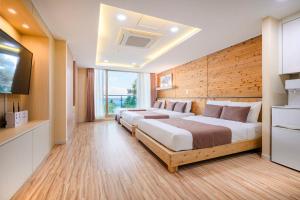 Postel nebo postele na pokoji v ubytování Jeju M Resort