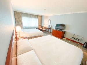 Gulta vai gultas numurā naktsmītnē Evergreen Laurel Hotel - Keelung