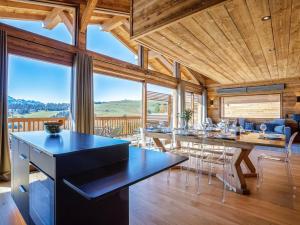 a kitchen and dining room with a table and chairs at Chalet luxueux avec jacuzzi, 7 pièces, proche pistes, pour 15 pers. - FR-1-810-28 in Hauteluce +3 photos
