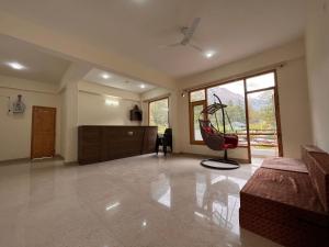a large living room with a swing in the middle at Winterline Hotel & Resort - Best Selling Property in Kasol in Kasol