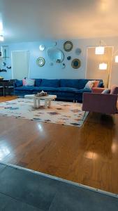 a living room with a blue couch and a table at Gallé Fulbé - Hidden Luxury in Detroit