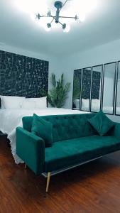 a green couch in a room with a bed at Gallé Fulbé - Hidden Luxury in Detroit