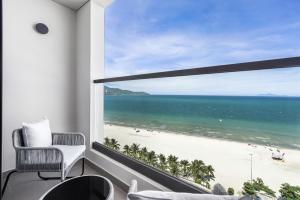a view of a beach from a room with a window at Radisson RED Danang in Da Nang