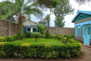 a garden in front of a house at Adorable Homely Stay in Nakuru