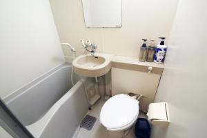 a small bathroom with a toilet and a sink at Nogata House in Tokyo