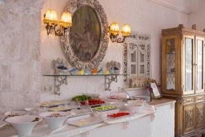 a kitchen with bowls of food on a counter at Lukka Exclusive Hotel – Adult Only +12 in Kaş
