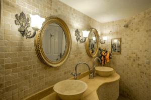 a bathroom with two sinks and two mirrors at Lukka Exclusive Hotel – Adult Only +12 in Kaş