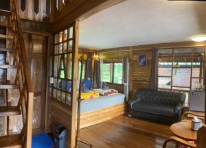 a living room with a couch in a tiny house at Baan IngDao MaekamPong Chiang Mai in Ban Pok Nai