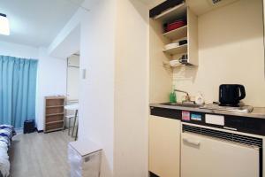 a small kitchen with a sink and a counter top at Nogata House in Tokyo +11 photos