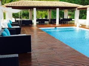 a swimming pool with chairs and a table at Finca Seguró in Sella +23 photos