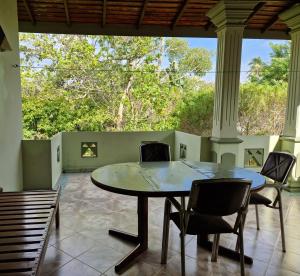 a table and chairs in a room with a large window at Castle villa in Hikkaduwa