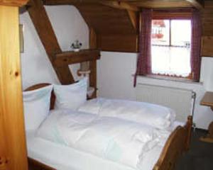 a white bed in a room with a window at Hotel Restaurant Schrotmühle in Scheinfeld