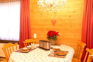 a dining room with a table with a microwave at MOM - Alpine Boutique Apartments, Romantica, near Grindelwald Terminal in Grindelwald