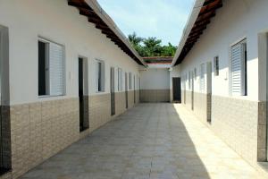 an empty corridor of a building with windows at Pousada Pantanal in Itanhaém