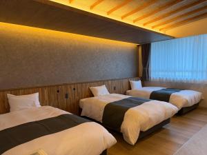 Letto o letti in una camera di 南紀月の瀬温泉ぼたん荘