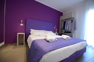 Posteľ alebo postele v izbe v ubytovaní Hotel Nuova Orchidea