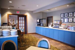 a restaurant with a counter with plates on it at Country Inn & Suites by Radisson, Gettysburg, PA in Gettysburg
