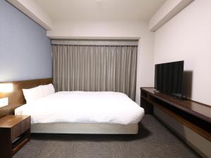 Cama ou camas em um quarto em Dormy Inn Wakkanai