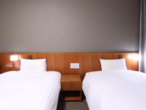 Cama ou camas em um quarto em Dormy Inn Wakkanai