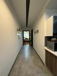 a hallway with white walls and a kitchen with a counter at Gulberg Heights in Islamabad +16 photos