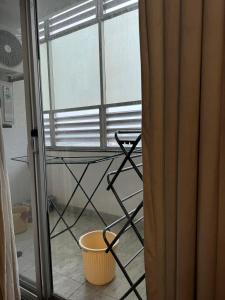 a room with a table and a chair in front of a window at Gulberg Heights in Islamabad