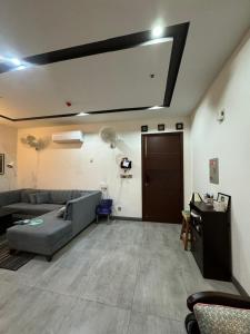a living room with a couch and a table at Gulberg Heights in Islamabad
