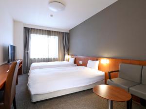 Cama ou camas em um quarto em Dormy Inn Wakkanai