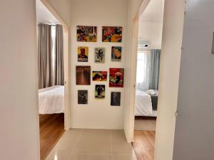 un pasillo con fotos en las paredes de un dormitorio en Davao Airport Family Transient, en Davao City