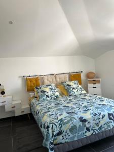 a bedroom with a bed with blue and white sheets at brin de mer in Saint-Pierre