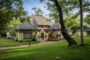a house with a green yard at First Group Sanbonani Resort in Hazyview
