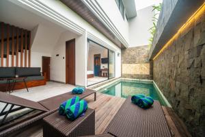 a house with a swimming pool and a living room at 3Bedroom - 703 - Private Pool Villa Sanur in Sanur
