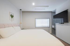 Postel nebo postele na pokoji v ubytování Gwangalli Hotel primavera in Busan
