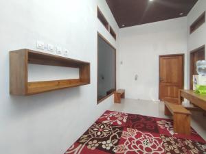 Postel nebo postele na pokoji v ubytování Dieng Ananda Mountain View Syariah RedPartner