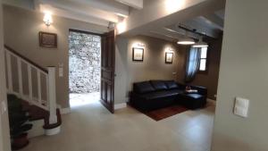a living room with a black couch and a window at Marietta's House in Rhodes Town