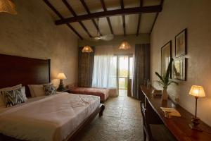 a bedroom with a large bed and a window at Artist Beach House in Morjim