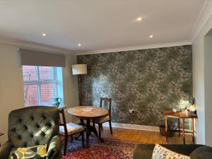 a living room with a table and a couch at The Garden House in Bishop Burton