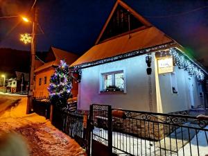 a house with a christmas tree and lights on it at Chalupa KLÁRA -Liptov in Ružomberok