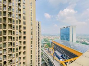 une vue d'un bâtiment avec un train sur le toit dans l'établissement Good Place and Spacious Studio Transpark Cibubur Apartment By Travelio, à Depok