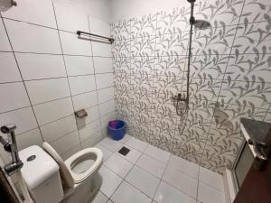 a bathroom with a toilet and a shower at Comfortable Apartment Bahria town Rawalpindi in Rawalpindi