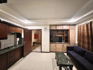 a living room with a couch and a kitchen at Comfortable Apartment Bahria town Rawalpindi in Rawalpindi +12 photos