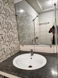 a bathroom with a sink and a mirror at Comfortable Apartment Bahria town Rawalpindi in Rawalpindi