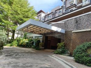 an entrance to a brick building with awning at 2bedrooms 2toilet& bath Matina Enclaves Condo in Davao City