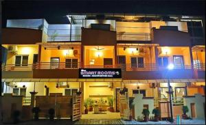 a building with a sign in front of it at night at Hotel Smart Rooms in Bhopal