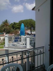 a view of a balcony with a blue fountain at Marina Azzurra VistaMare - HiTuscany in Marina di Campo