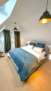 a bedroom with a large bed with a blue blanket at Plum Cottage Somerset in Wells +29 photos
