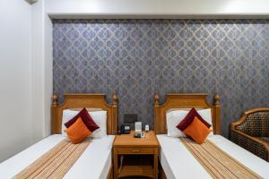 Postel nebo postele na pokoji v ubytování Hotel Sunstar Grand