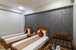 Postel nebo postele na pokoji v ubytování Hotel Sunstar Grand
