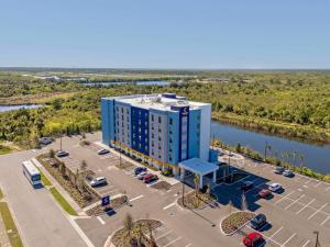 an aerial view of a building with a parking lot at Comfort Suites Titusville near Kennedy Space Center in Titusville